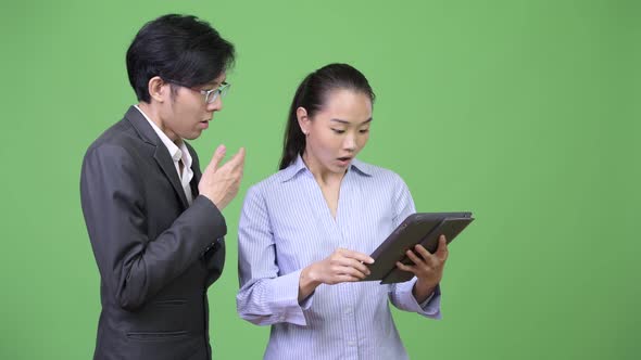 Young Asian Business Couple Having Meeting Together