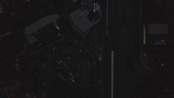 Sideways Aerial Birds Eye Overhead Top Down View of Train Passing By on London Bridge Train Station alt