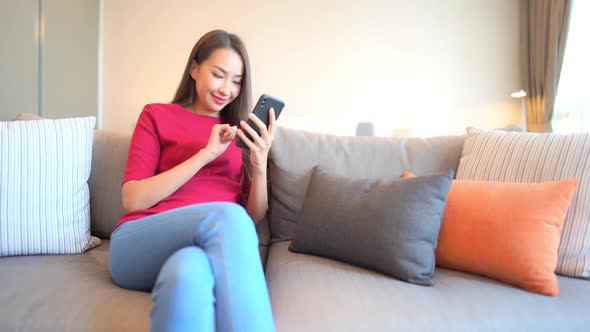 Young asian woman use smart phone alt