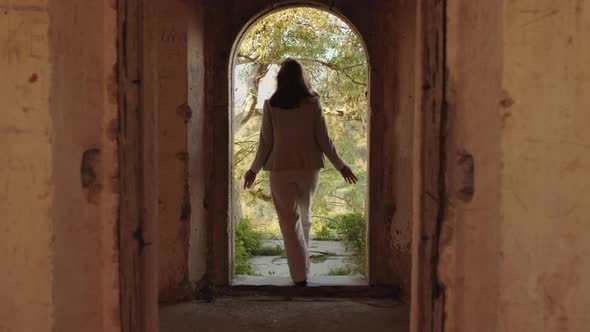 girl goes through ancient door alt