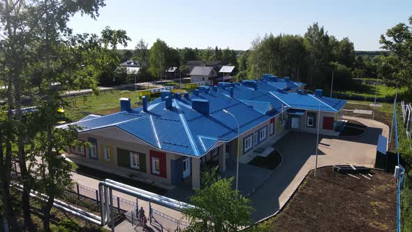 Kindergarten Building with Blue Roof in Countryside
