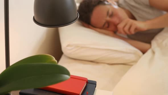 Senior Caucasian woman and her daughter sitting by a table in an apartment alt