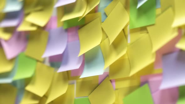 The collage of multiple colorful post-it notes on the wall with idea text.