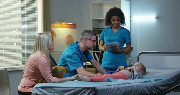 Doctor Examining Girls Abdomen alt