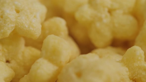 Heap of Yellow Cereal Corn Stars on Rotating Surface  Close Up Selective Focus