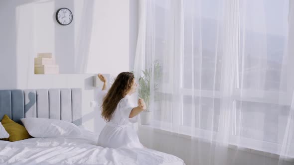 Lady in Hotel Room Enjoying Sunny Morning