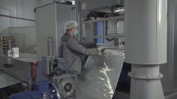 Camera Approaches To Serious Man in Face Mask Controlling Process of Manufacturing in Factory. Male alt