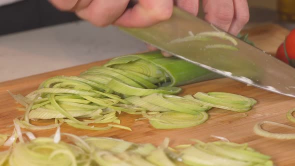 Chef Masterfully Cutting Colorful Vegetables on Cutting Board