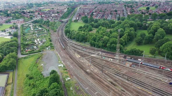 Aerial drone footage of railway depot and railway tracks in the summer time showing lots of trains alt