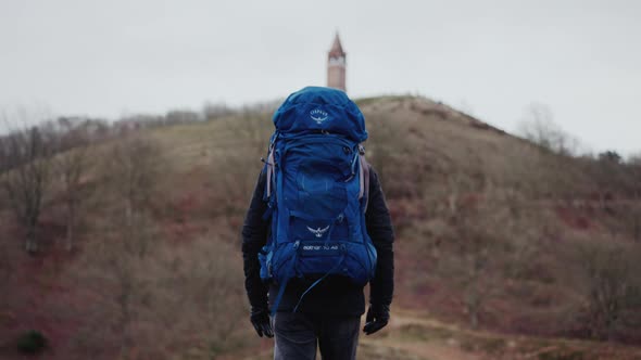 Tourist with Huge Backpack Walks Along the Hills in Himmelbjerget Area Denmark alt