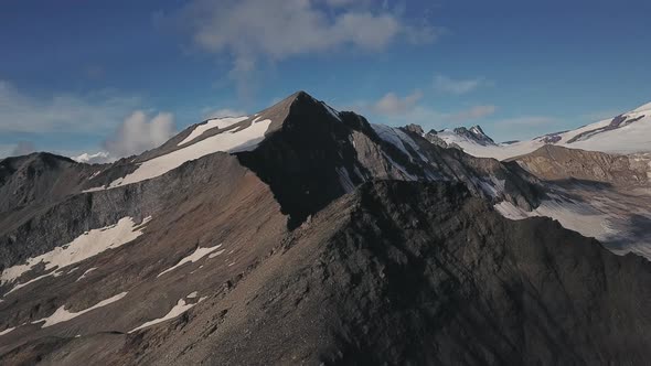 Aerial Panorama with a Rocky Mountain Peaks Rarely Covered with Snow