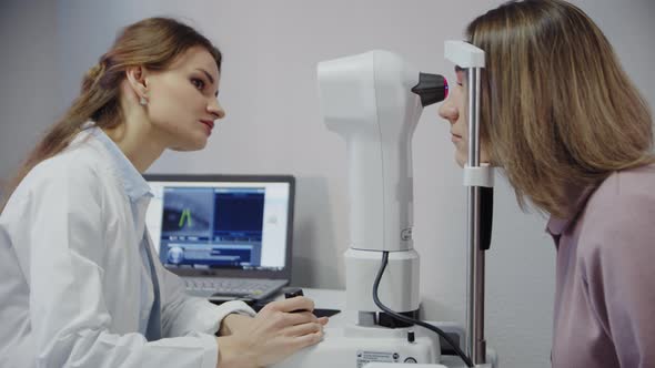 The Ophthalmologist Examines the Patient's Eye and Then Looks Into the Camera alt