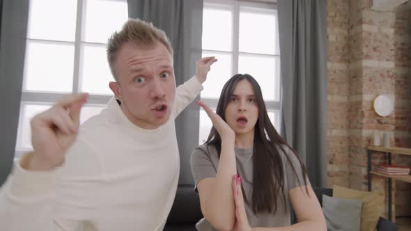 Ecstatic Young Couple Dancing and Singing before Camera alt