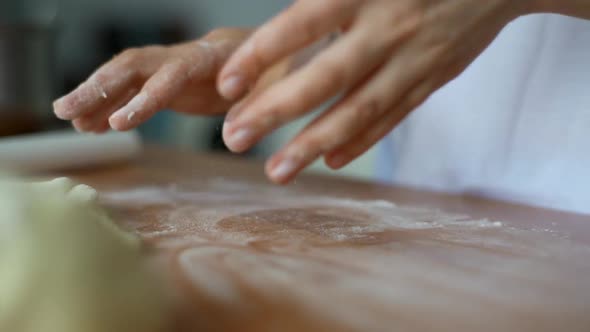 Woman Rolls the Dough with a Rolling Pin Shaping the Dough alt