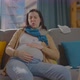Pregnant Young Woman Gets Sick Sneezes and Gets Sick Sitting on the Couch at Home - VideoHive Item for Sale
