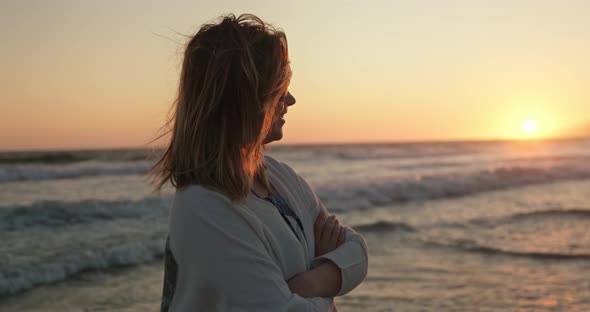 Close Up Portrait of Beautiful Caucasian Woman Looking at the Golden Sunset.  alt