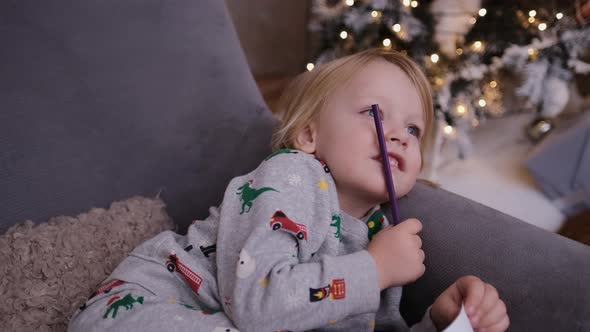 A Little Boy Dreams of What To Write To Santa Claus