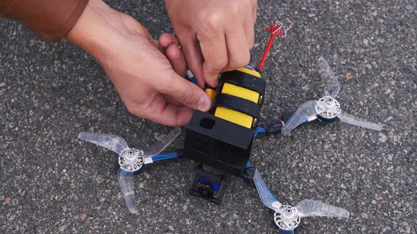 FPV Drone Pilot Connects Battery To Drone
