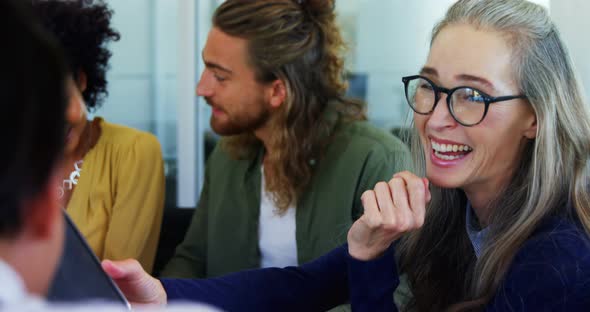 Happy colleagues interacting with each other 4k alt