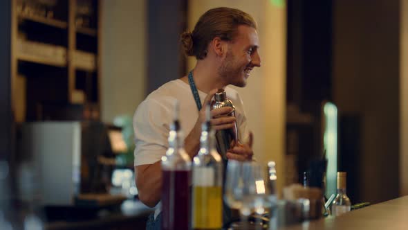 Sexy Barman Mixing Cocktails at Counter alt