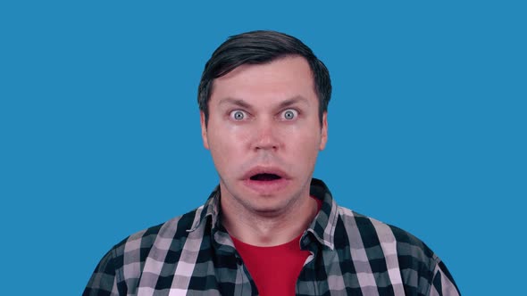 A funny man with a big mouth looks ahead. alt