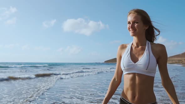 Young Woman Walking on Beach alt