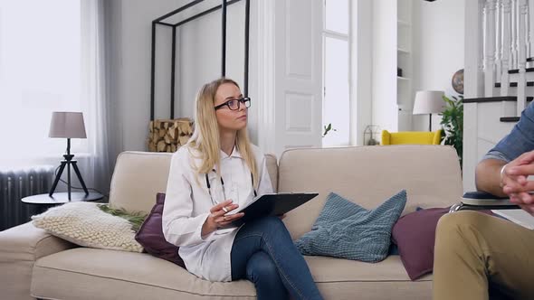 Man Telling About His Phisical Condition After Accident to His Personal Medical Nurse  alt