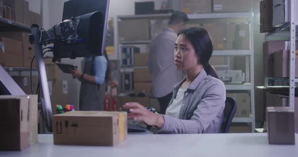 Woman Checking Packages with Barcode Scanner alt