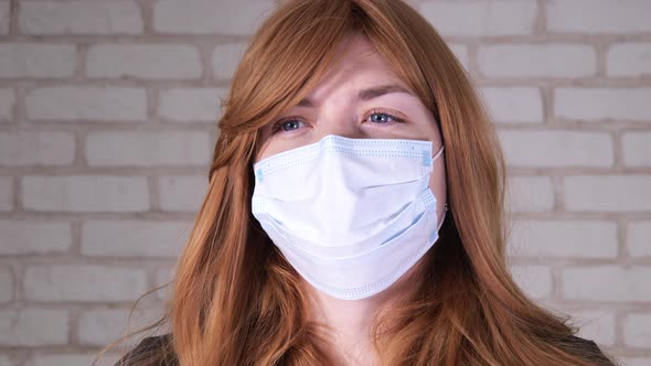 Girl in a Medical Mask Looking at the Camera