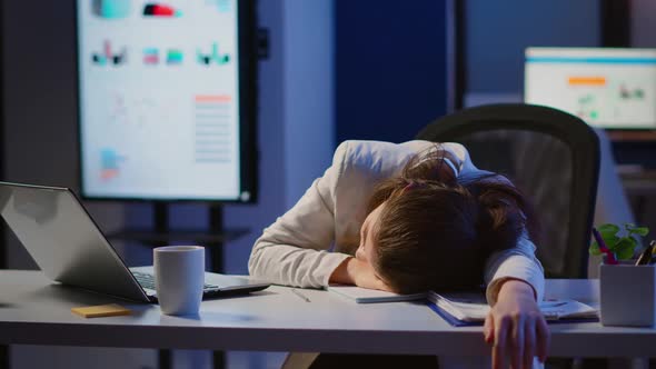 Freelancer Working Overtime Falling Asleep with Hand on Financial Documents alt
