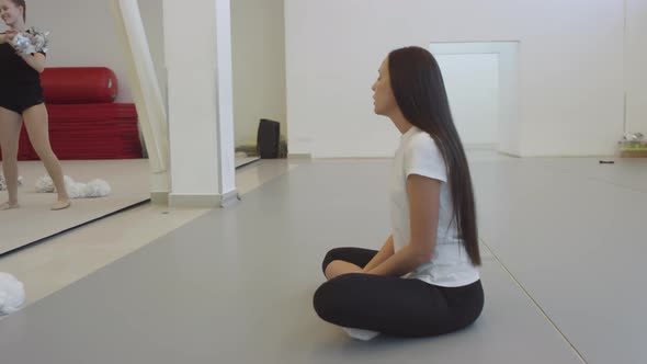 Female Cheer Coach Teaching Girls Doing Stunt alt