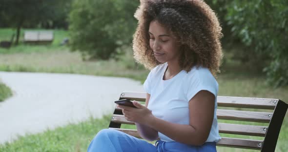 Smiling African American Modern Casual Lady Gesticulate Emotionally Talking on Telephone alt