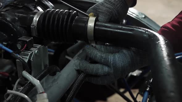 Mechanic Remove the Fuel Pipe Filter From Under the Hood Space of the Car