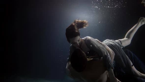 Young Man and Woman Are Swimming Underwater and Embracing Romantic and Love of Couple alt