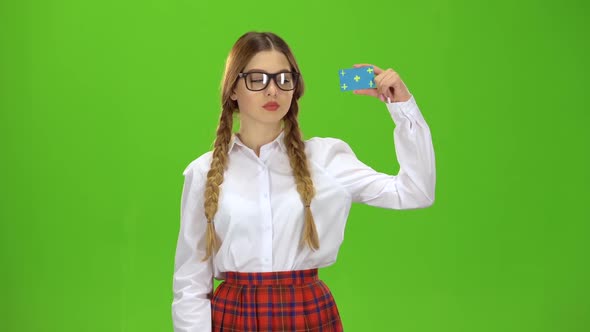 Teen in Glasses Raises a Card and Shows a Ok . Green Screen alt