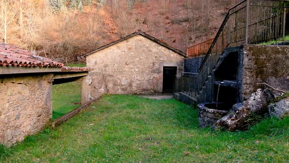 POV Walking Back Along Grass In With Abandoned Rustic Water Mill Building With Old Traditional Clay alt