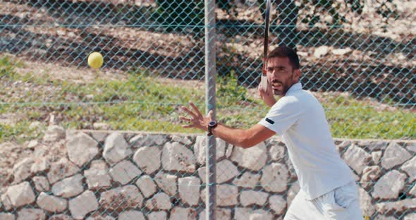 Slow motion of a tennis player hitting the ball during a tennis game alt
