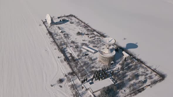 Aerial View of the Space Communication Station in Snow Covered Field at Sunny Winter Day Drone