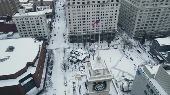 American Flag Waving Over Snow Covered Pioneer Square in Portland During Winter alt