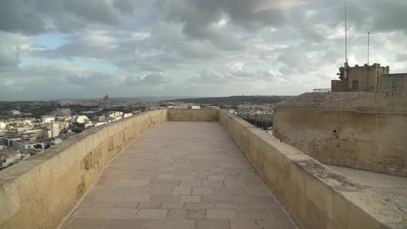 Walking on Defensive Cittadella Fortress Wall on Cloudy Stormy Windy Day in Gozo Island