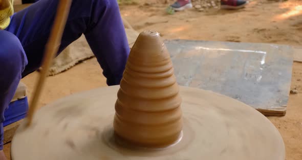 Potter Spinning the Potter Wheel and Making Clay Vase. Udaipur, Rajasthan, India alt