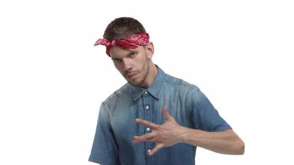 Confident Bearded Guy with Red Bandana Over Forehead Showing Westcoast Rap Sign and Looking Sassy