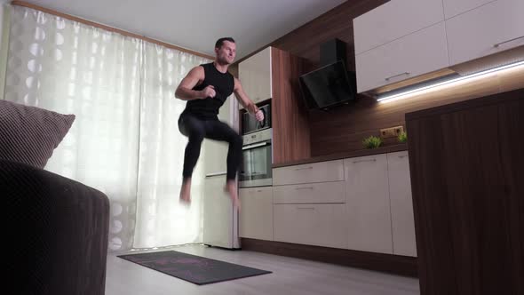 A Man Performs an Endurance Exercise in a Home Environment alt