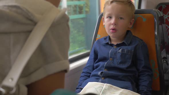 Child with Map in Commuter Train alt