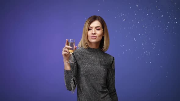 Woman in Silver Shirt Holding Glass of Champagne and Smiling