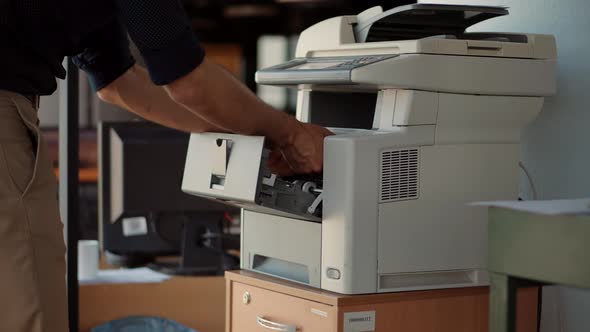 Man Using Printer Or Scanner In Office. Businessman Printing Document On Workplace. Copier. alt