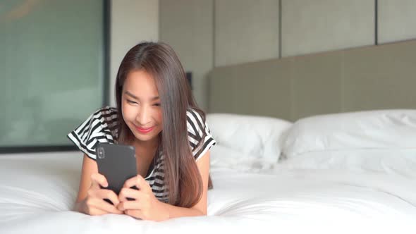 Young asian woman use smart phone alt