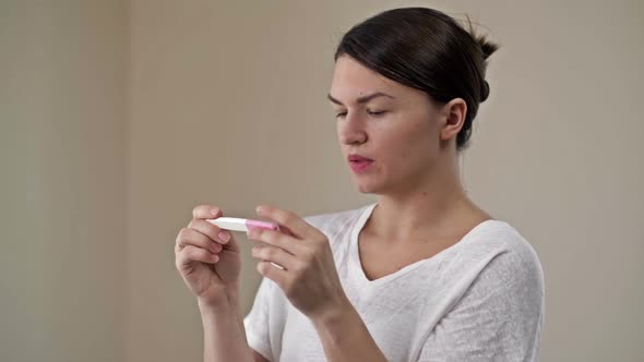 Woman Rejoices at Pregnancy Test Results
