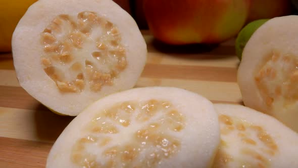 Panorama of Exotic Guava Slices Lying on a Bamboo Board alt