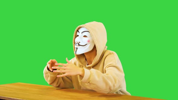 Dangerous Hacker with Masked Face Speak Threatening Users and Business Company with Malware Programs alt